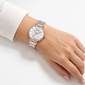 Montre femme bicolore Minoran 9087 portée au poignet sur fond blanc