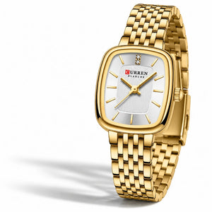 Montre femme dorée Minoran 9093 posée sur un tissu blanc et photographiée de face