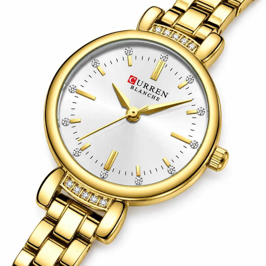 Montre Minoran 9098 dorée à cadran blanc en zoom diagonal, avec index en bâtons et détails brillants