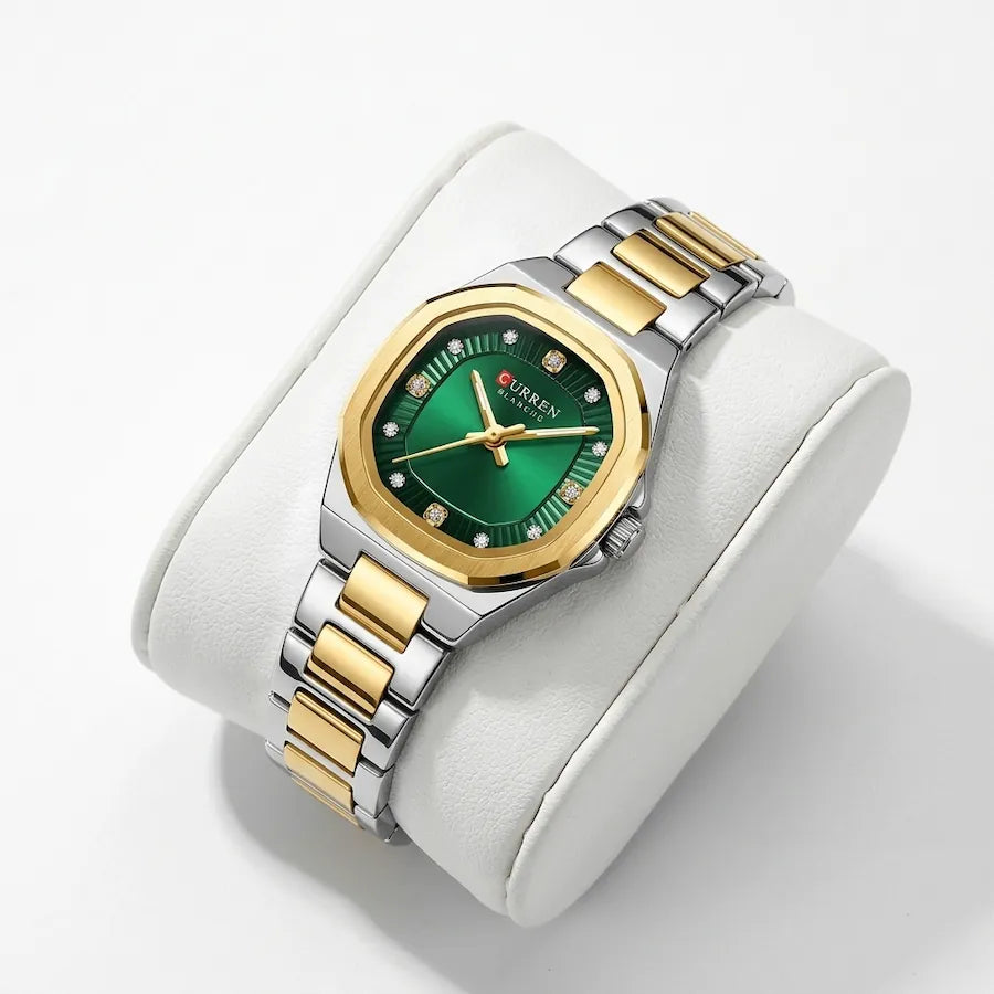 Montre femme bicolore à cadran vert Minoran 9101, présentée sur un coussin blanc