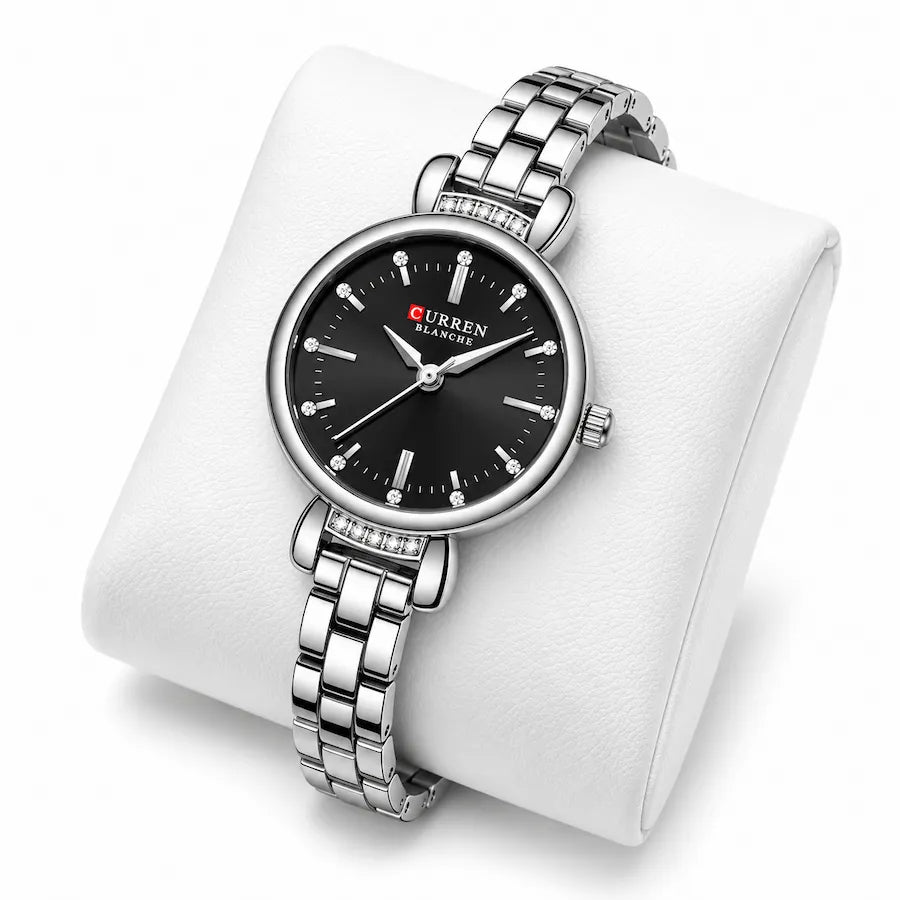 Montre femme argentée à cadran noir Minoran 9098 présentée sur un coussin blanc
