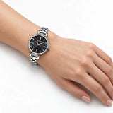 Montre femme argentée à cadran noir Minoran 9098 portée au poignet