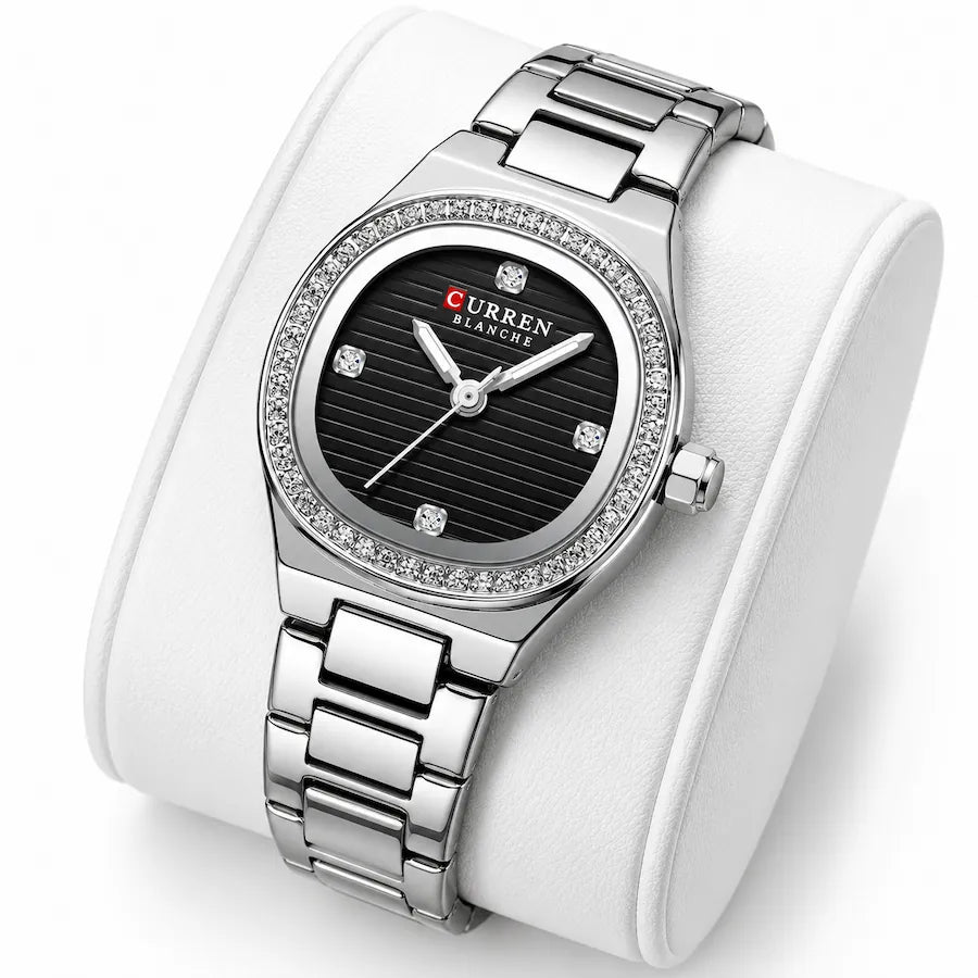 Montre femme argentée à cadran noir Minoran 9101 sur coussin blanc