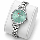 Montre femme argentée à cadran vert menthe Minoran 9098 présentée sur un coussin blanc