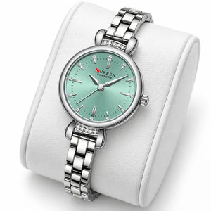 Montre femme argentée à cadran vert menthe Minoran 9098 présentée sur un coussin blanc