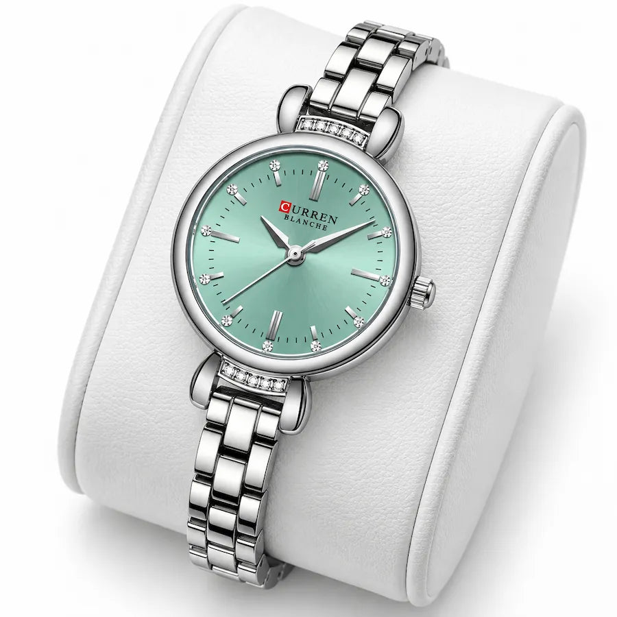 Montre femme argentée à cadran vert menthe Minoran 9098 présentée sur un coussin blanc