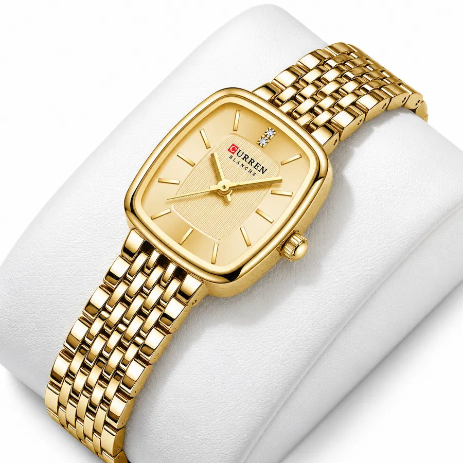 Montre femme dorée Minoran 9093 à cadran doré présentée sur un coussin blanc