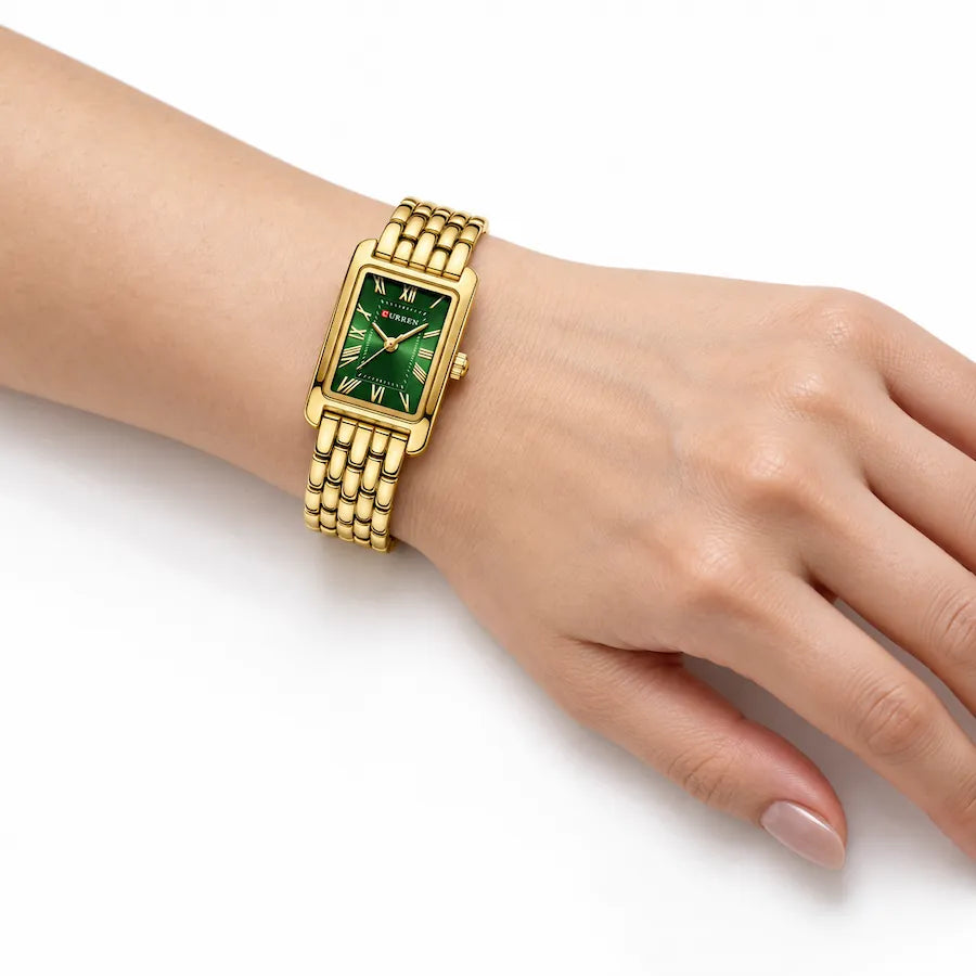 Montre rectangulaire dorée Minoran 9115 portée au poignet, cadran vert visible