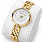 Montre femme dorée Minoran 9052 présentée sur un coussin blanc