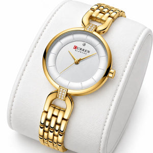 Montre femme dorée Minoran 9052 présentée sur un coussin blanc