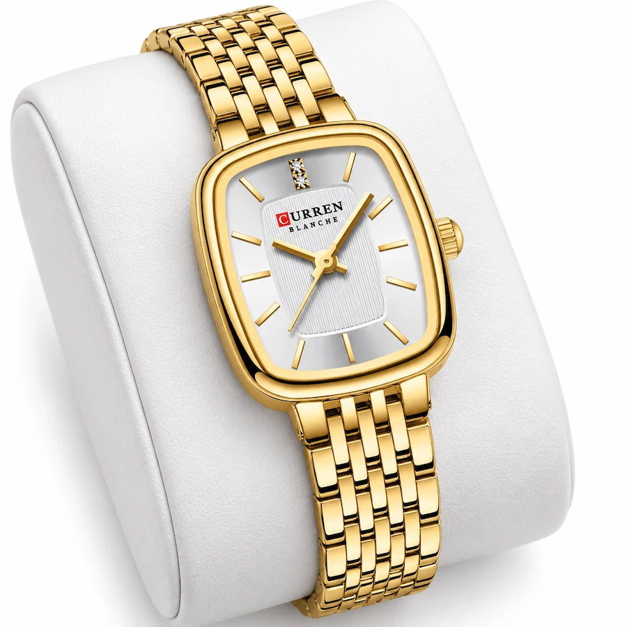 Montre femme dorée Minoran 9093 présentée sur un coussin blanc, avec son cadran rectangulaire visible