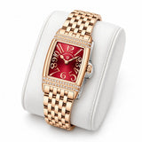 Montre Minoran PD-1737 dorée à cadran rouge posée sur un coussin blanc