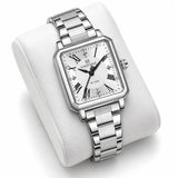 Montre Minoran NF5065 argentée à cadran blanc présentée sur un coussin blanc, bracelet à maillons visible